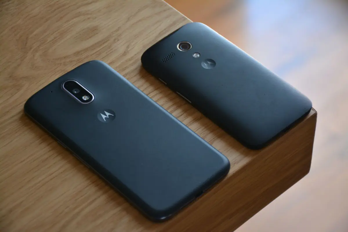 Two smartphones side by side on a wooden table