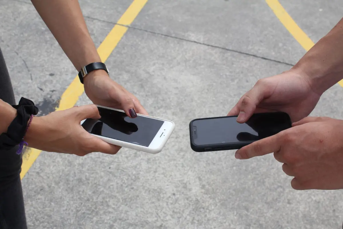 Two people comparing their smartphones
