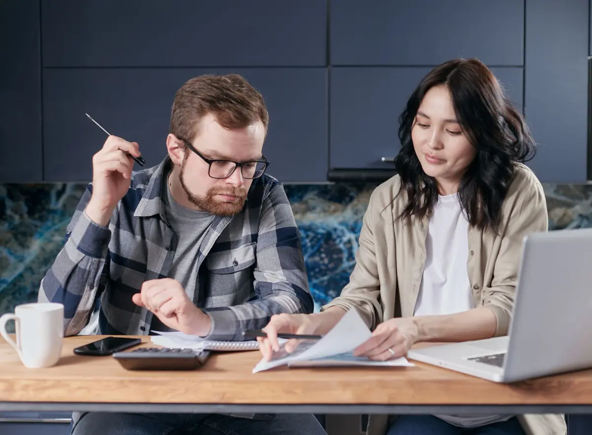 A couple reviewing household bills together